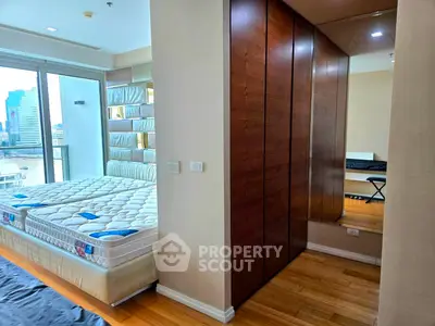 Spacious bedroom with city view and elegant wooden wardrobe