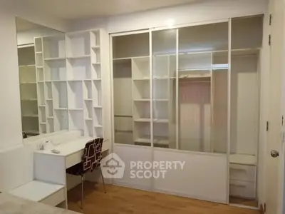 Spacious bedroom with built-in wardrobe and stylish shelving unit