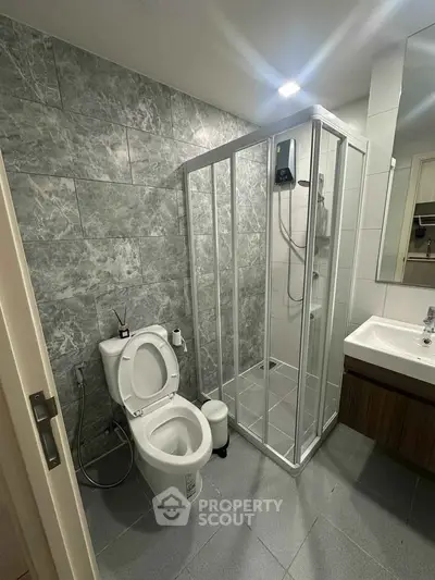 Modern bathroom with sleek shower and elegant gray tiles