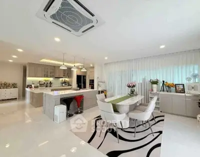 Spacious modern kitchen and dining area with sleek design and ample natural light.