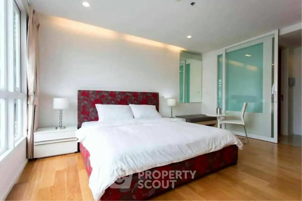 Spacious modern bedroom with large windows and elegant decor