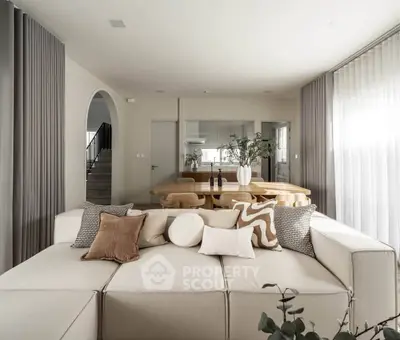 Spacious modern living room with elegant decor and open dining area