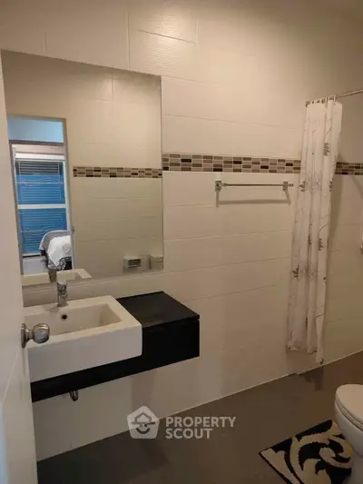 Modern bathroom with sleek sink and stylish tile accents