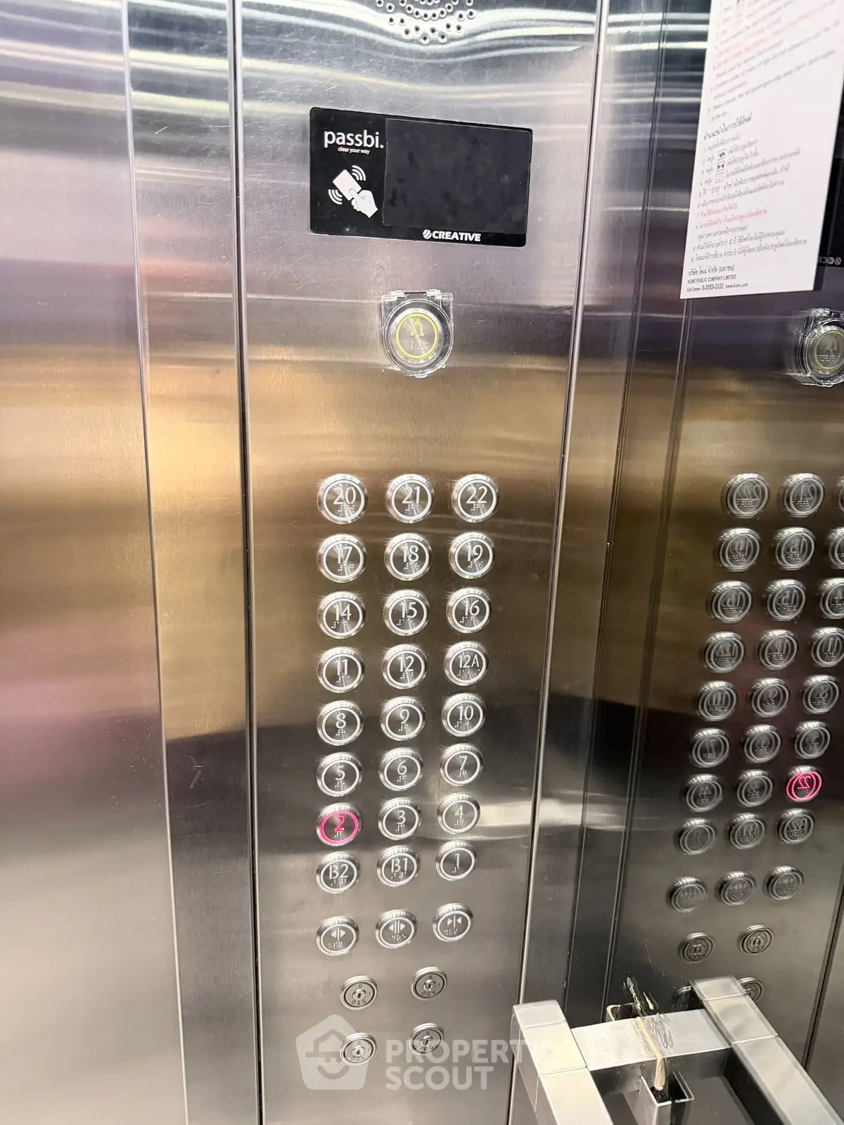 Modern elevator interior with sleek metallic finish and illuminated floor buttons.