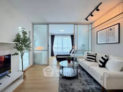 Modern open-plan living room with stylish decor and natural light