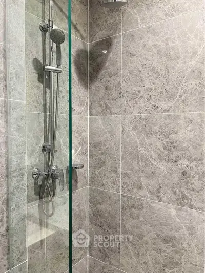 Modern bathroom shower with sleek marble tiles and glass enclosure