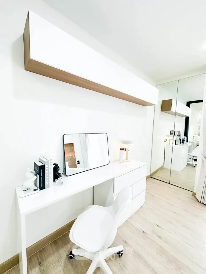 Modern study room with sleek white desk, chair, and mirrored wardrobe in bright minimalist design.