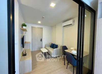 Modern living room with cozy seating and dining area in a stylish apartment.
