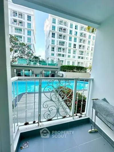 Charming balcony view overlooking luxurious pool and modern apartment complex