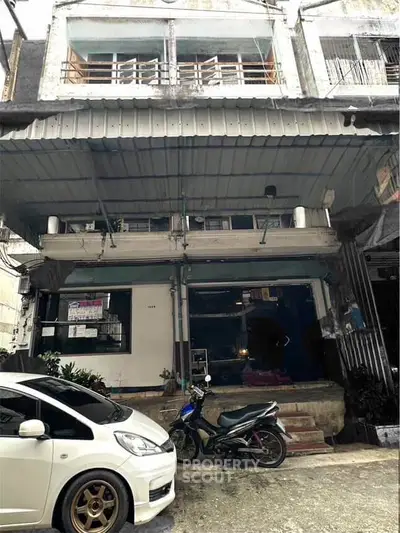 Urban commercial building with parking space and street view