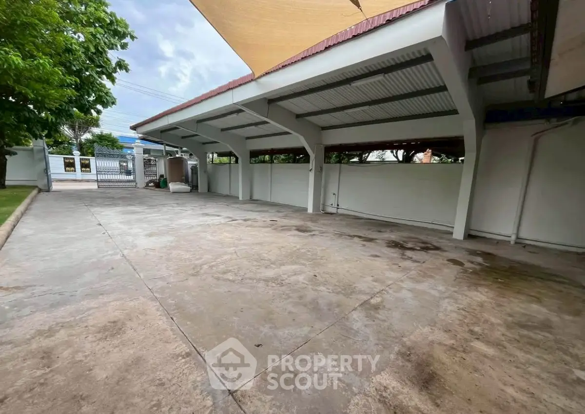 Spacious covered parking area with modern design and ample space for multiple vehicles.