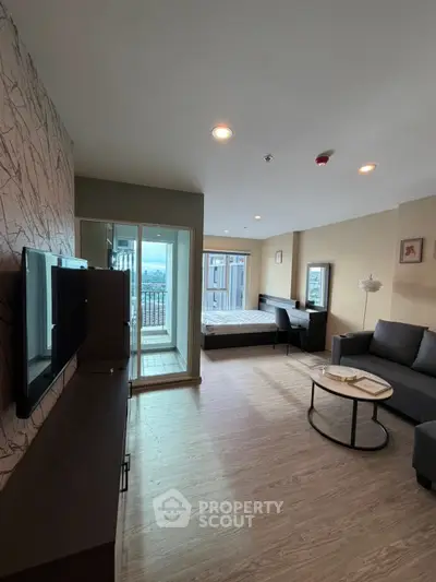 Modern studio apartment with stylish decor and balcony view