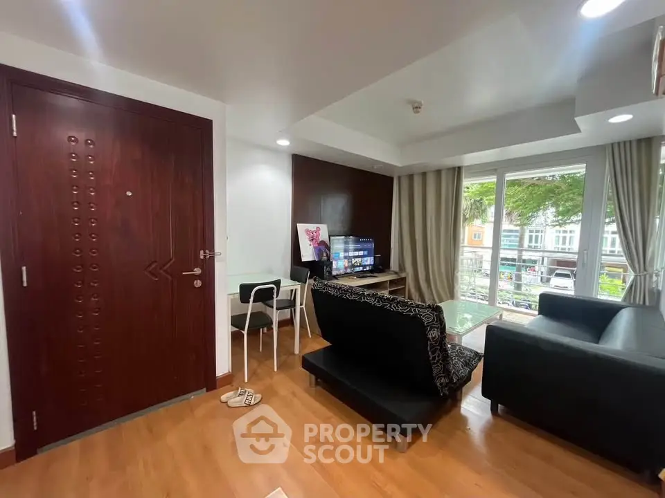 Modern living room with stylish decor and large windows offering natural light.