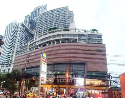 Stunning view of Grand Parva building with modern architecture and vibrant city life.