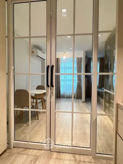 Modern living room with glass doors and elegant dining area