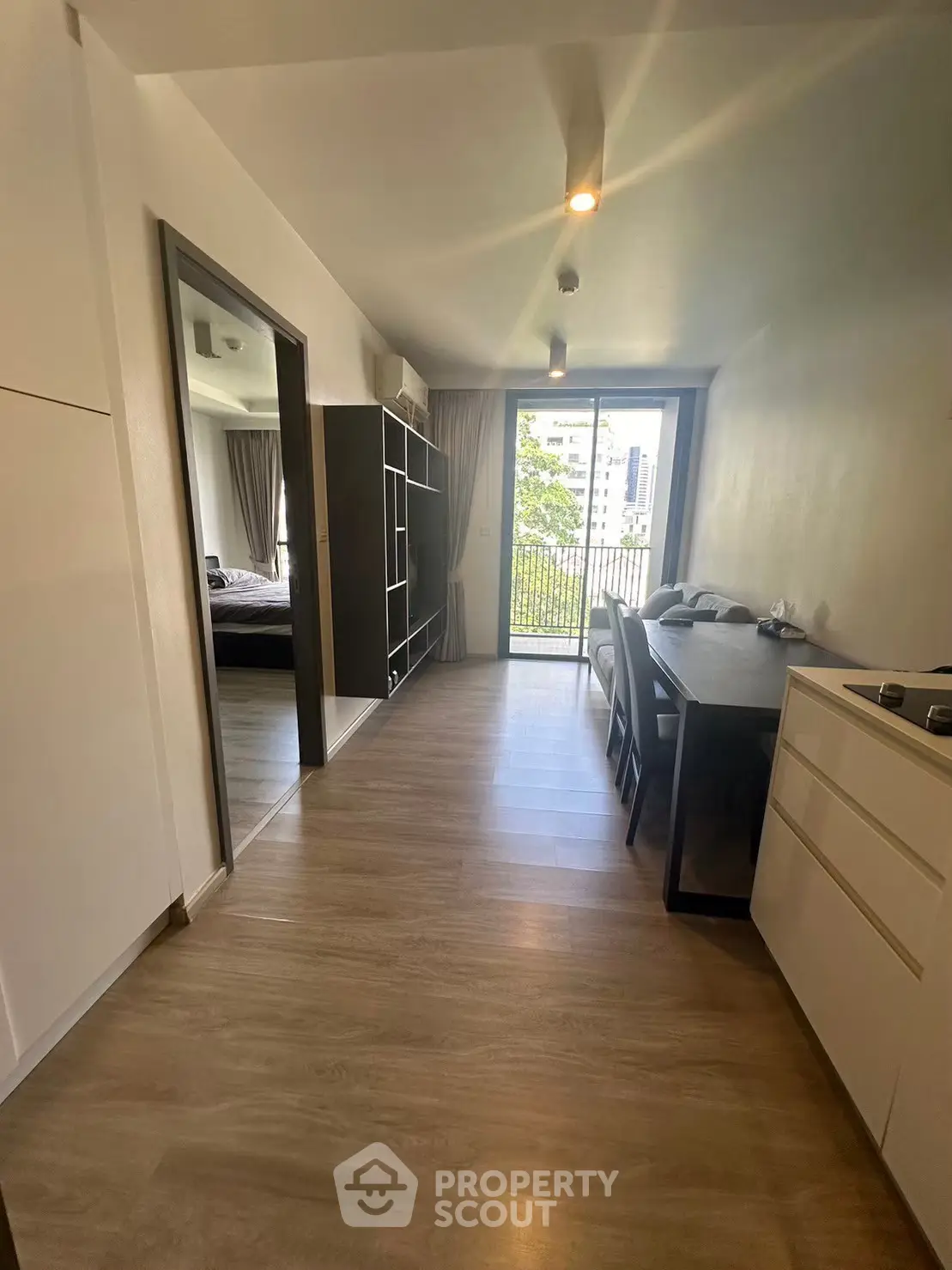 Modern apartment interior with open layout and balcony view