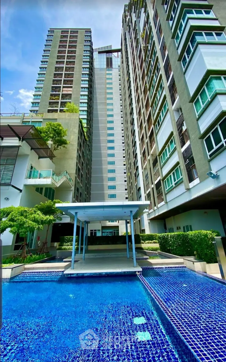Luxurious high-rise apartment with stunning pool and modern architecture.