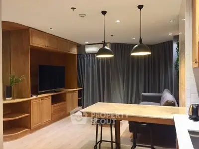 Modern living room with wooden furniture and cozy lighting, featuring a TV and comfortable seating area.