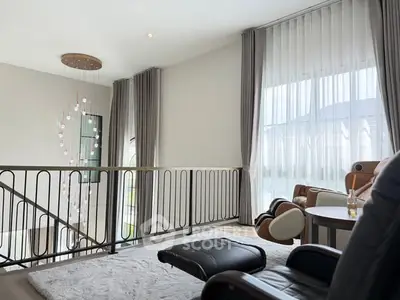 Elegant living room with modern decor and large windows offering natural light