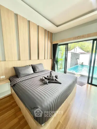 Luxurious bedroom with pool view and elegant wooden accents