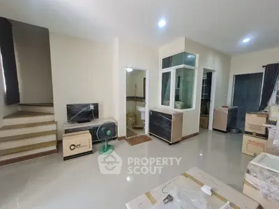 Spacious modern living area with staircase and natural light