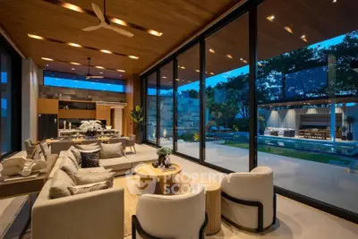 Luxurious open-plan living room with stunning pool view and modern decor