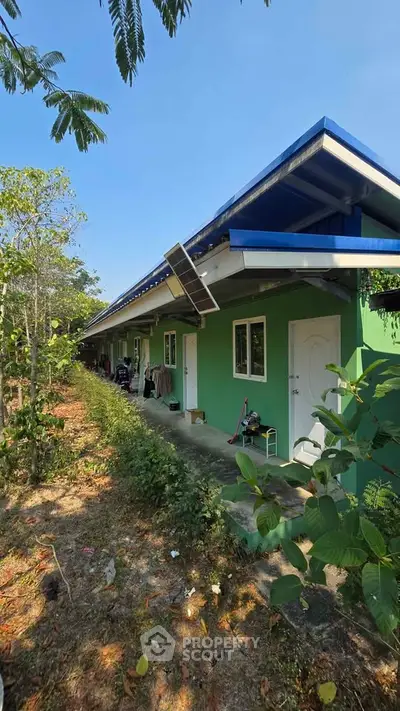 Charming green residential building with solar panels and lush surroundings