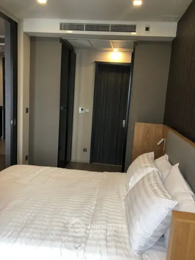 Modern bedroom with sleek design and cozy ambiance in a contemporary apartment.