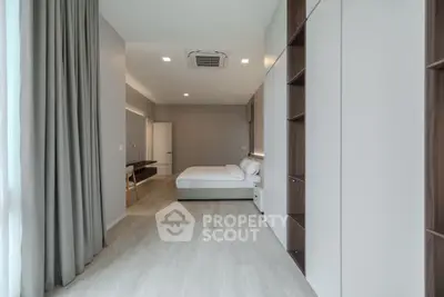 Spacious modern bedroom with sleek design and ample natural light