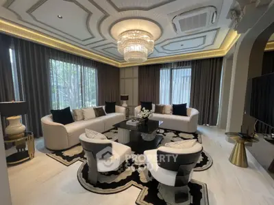 Luxurious living room with elegant chandelier and modern furniture, perfect for sophisticated gatherings.