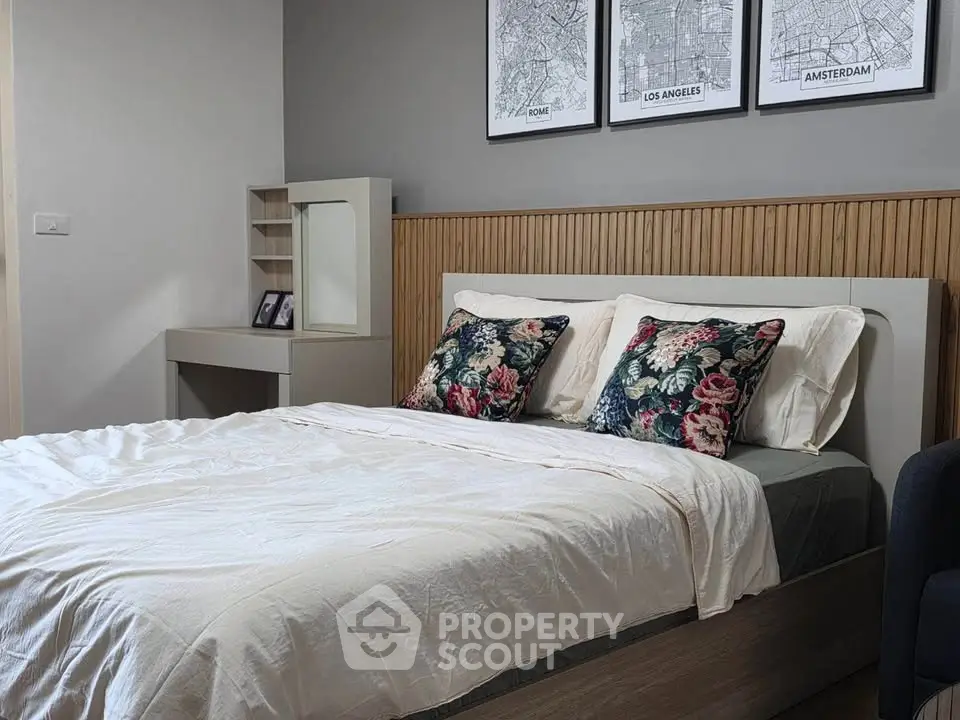Cozy bedroom with stylish decor and floral pillows, perfect for relaxation.