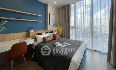 Modern bedroom with city view, featuring stylish decor and floor-to-ceiling windows.