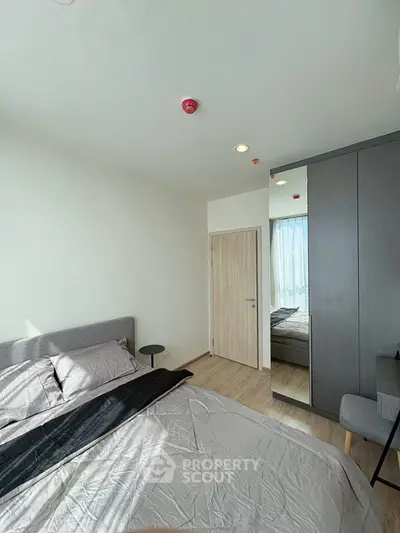 Modern bedroom with sleek design and ample natural light