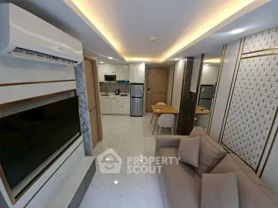 Modern living room with open kitchen, sleek design, and stylish decor in a contemporary apartment.