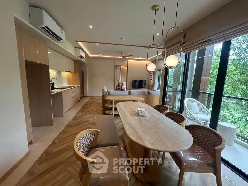 Luxurious open-plan living room with elegant dining area and scenic balcony view.