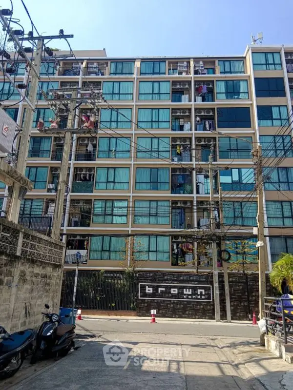 Modern urban apartment building with large windows and street view