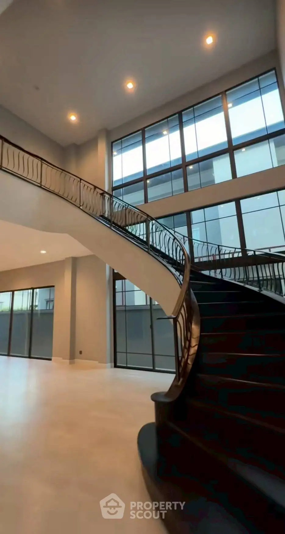 Luxurious modern staircase with elegant railing in spacious open-plan interior