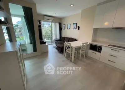 Modern living room with open kitchen and balcony view