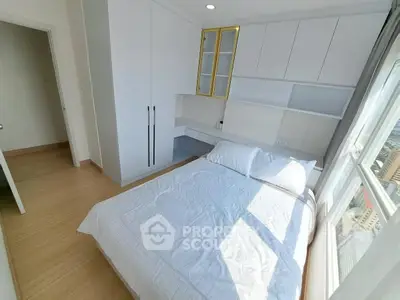 Bright modern bedroom with large window and built-in storage