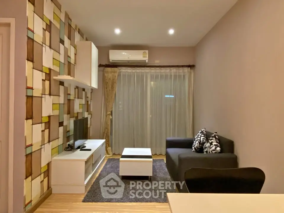 Modern living room with stylish decor and cozy seating area, perfect for relaxation.