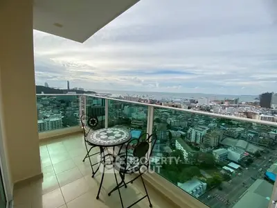 Stunning high-rise balcony with panoramic city and ocean views, perfect for relaxation and entertainment.
