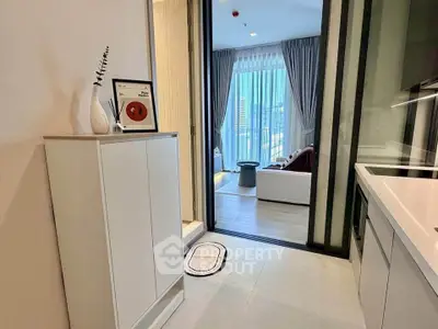 Modern apartment interior with sleek kitchen and cozy living area, featuring floor-to-ceiling windows and stylish decor.