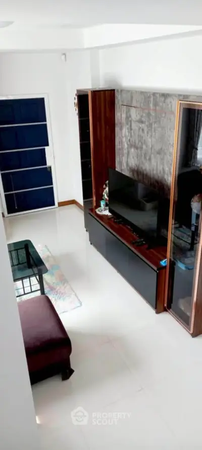 Modern living room with sleek furniture and large TV unit