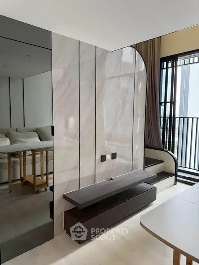 Modern living room with sleek design and large windows for natural light