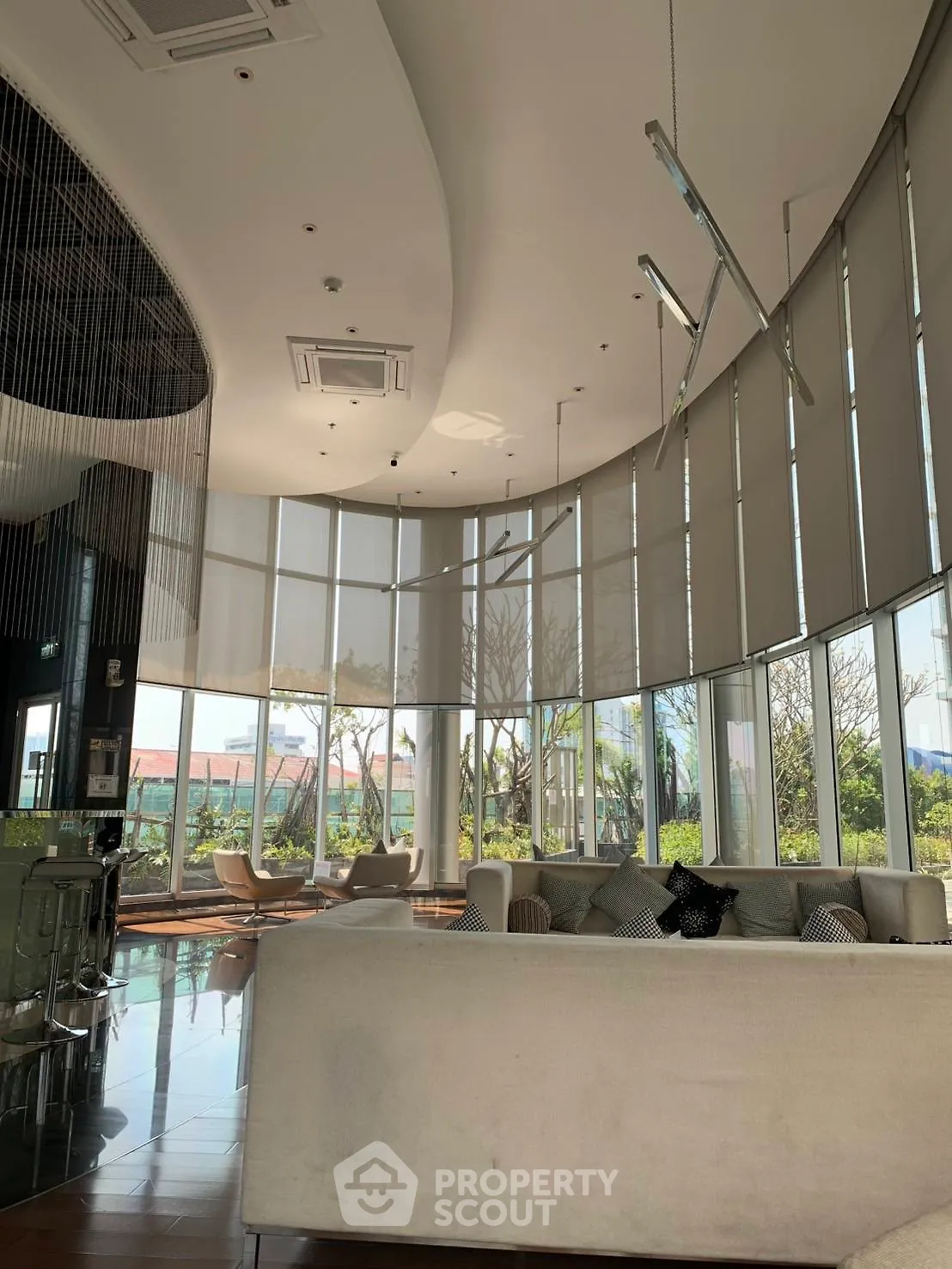 Luxurious modern living room with floor-to-ceiling windows and elegant decor