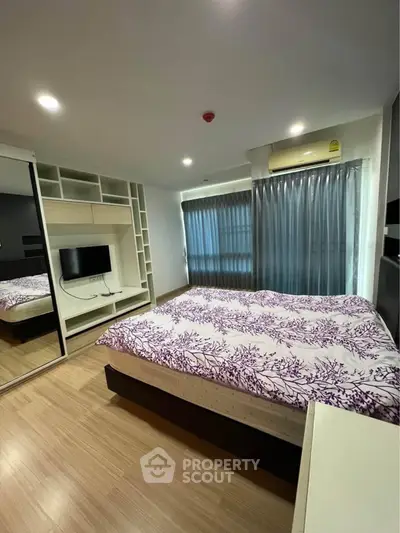 Modern bedroom with built-in storage and large window in stylish apartment