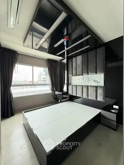 Modern bedroom with sleek black and white design, large window, and stylish ceiling.
