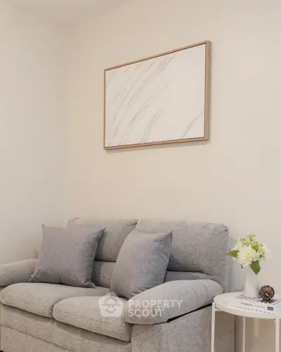 Cozy living room with modern gray sofa and elegant wall art