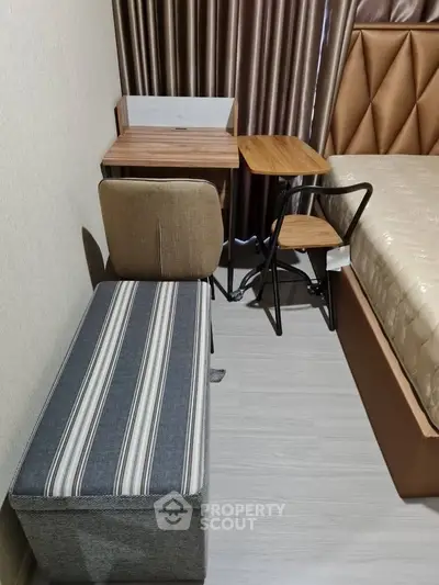 Cozy bedroom with modern furniture and elegant curtains, ideal for a comfortable living space.