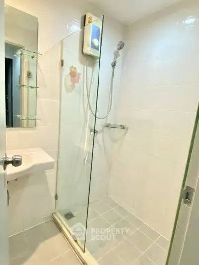 Modern bathroom with glass shower enclosure and sleek fixtures